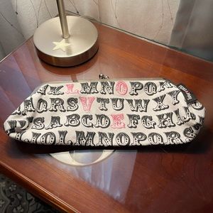 Two’s Company clutch. Clasp closure. White, black, pink.